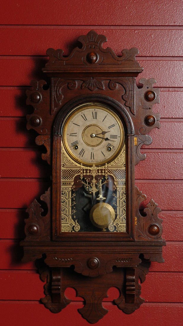 A SETH THOMAS HANGING KITCHEN CLOCK: Walnut, time and strike, orig dial, glass, measures 28 x 14 x 4 inches overall. Good running condition. Running condition is not guaranteed once the clock is moved.