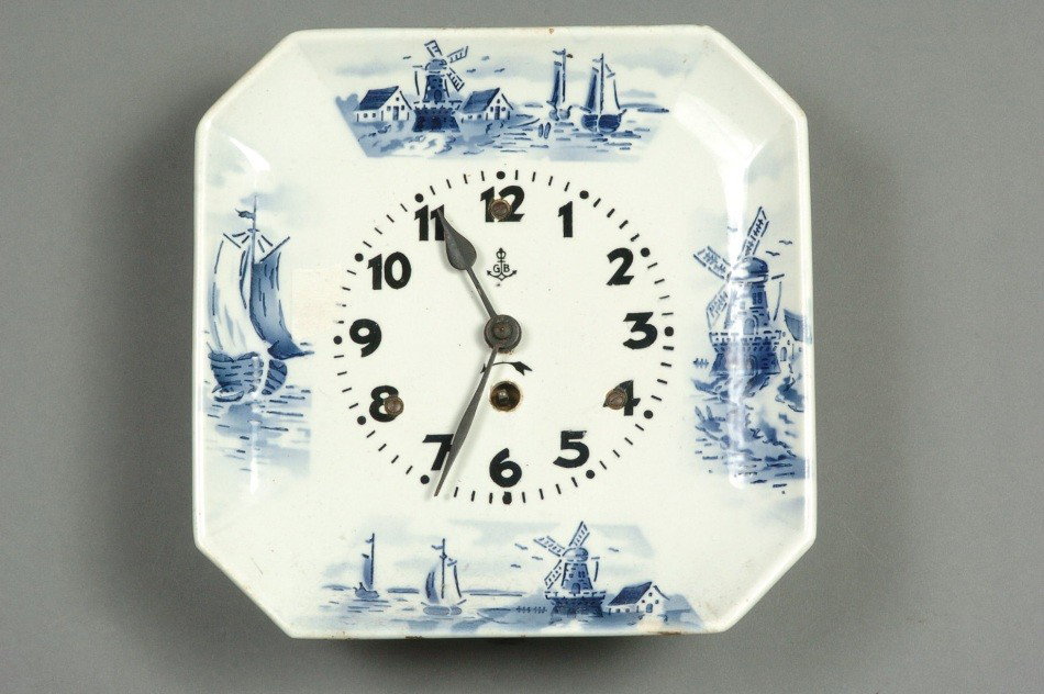 A GUSTAV BECKER PLATE CLOCK: Blue and white porcelain, signed on the dial, 8.75 x 8.75 x 3 inches.