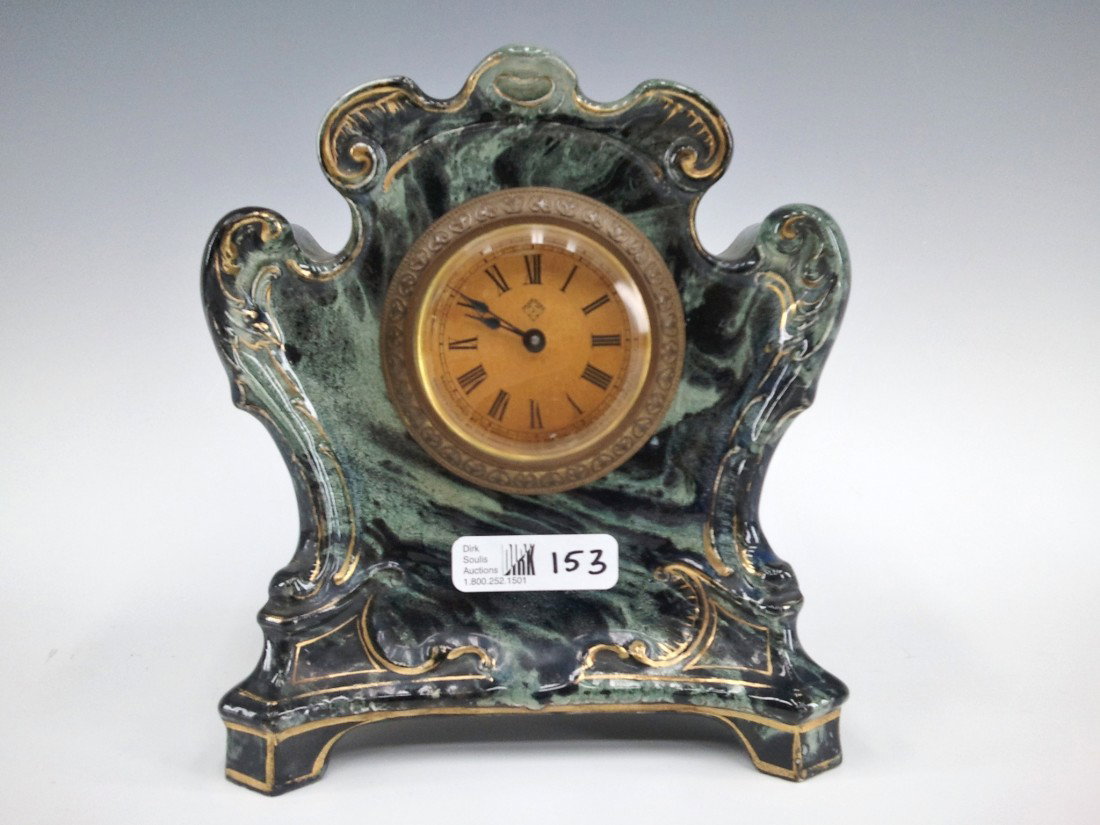 AN ANSONIA ROYAL BONN 'ARMOR' CHINA CLOCK: An unusual little china clock with original paper lable having Ansonia logo, measures 6 x 6 inches.