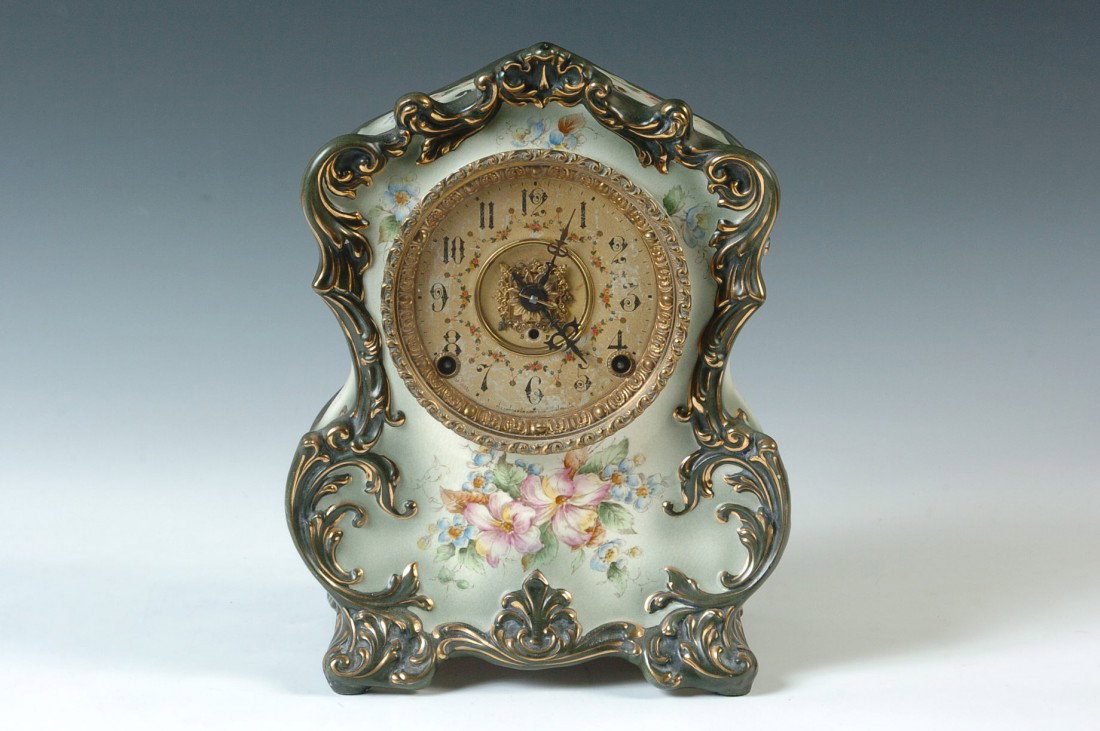 A NICE KROEBER CHINA CLOCK: Time and strike with fancy rosette in the center of the double sunk original paper lined dial with floral decorations. Floral transfers with hand painting, green trim with gold. Tag on reverse reads, 