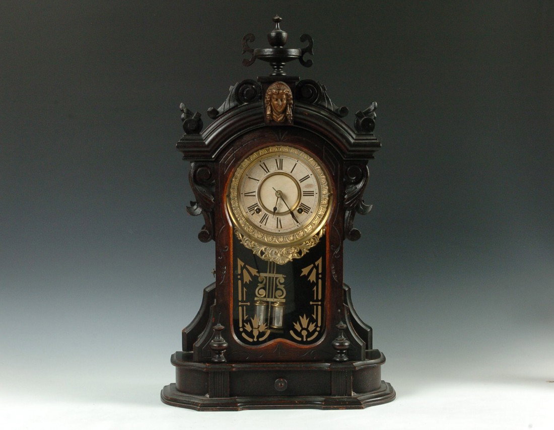 AN ANSONIA 'MONARCH' PARLOR CLOCK W/ DRAWER: The high end Ansonia parlor with carved wood urn over a bust of Columbia, extra fancy heavy brass beauty ring around the double sunk dial with original paper inserts, double vial pendulum, double deco
