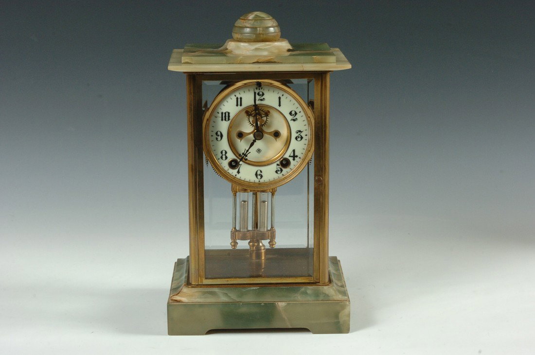 ANSONIA 'CHANCELLOR' CRYSTAL REGULATOR W/ ONYX: An unusual crystal regulator with natural onyx top and base. Good double sunk porcelain enamel dial with a line at the 10 position, exposed escapement with two ruby jewels and a faux mercury pendulum.