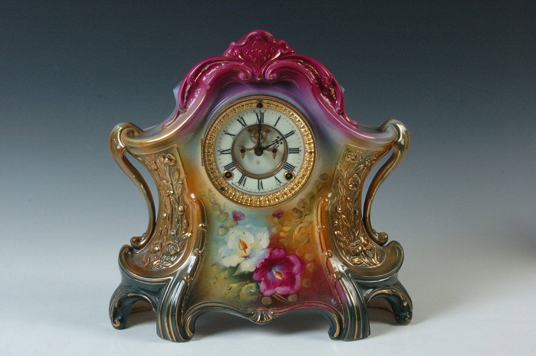 AN ANSONIA 'LA LAYON' ROYAL BONN CERAMIC CLOCK: A beautiful Royal Bonn cased Ansonia clock with hand painted floral designs that do not appear to be any part transfer, fine condition, the double sunk dial with exposed escapement is perfect, no chip
