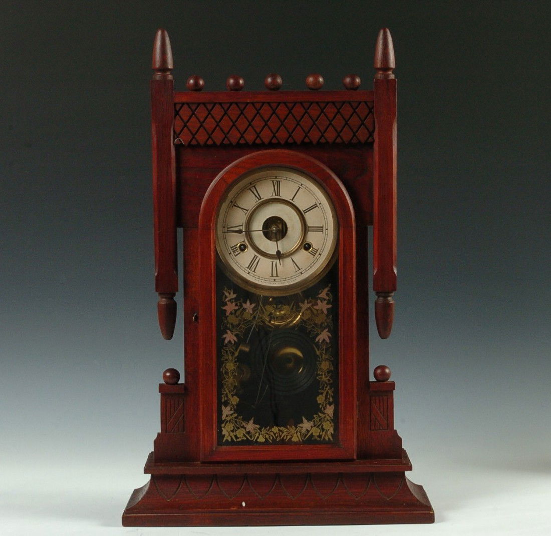 A NEW HAVEN OAK KITCHEN CLOCK: With two-color door glass, time, strike and alarm, measures 23.25 x 14.5 x 5 inches overall. Paper dials replaced, alarm dial is loose in the case,