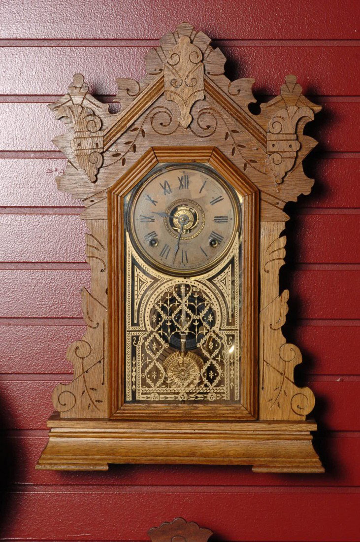 A SETH THOMAS OAK CASE HANGING KITCHEN GINGERBREAD: Restored, time, strike and alarm, measures 23 x 15 inches, Good running condition. Running condition is not guaranteed once the clock is moved.