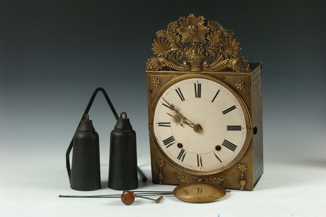 A FRENCH MOBIER WALL CLOCK: An antique French clock with detailed brass façade, enamel dial and folding pendulum, measures 17.5 x 10.5 x 6 inches.