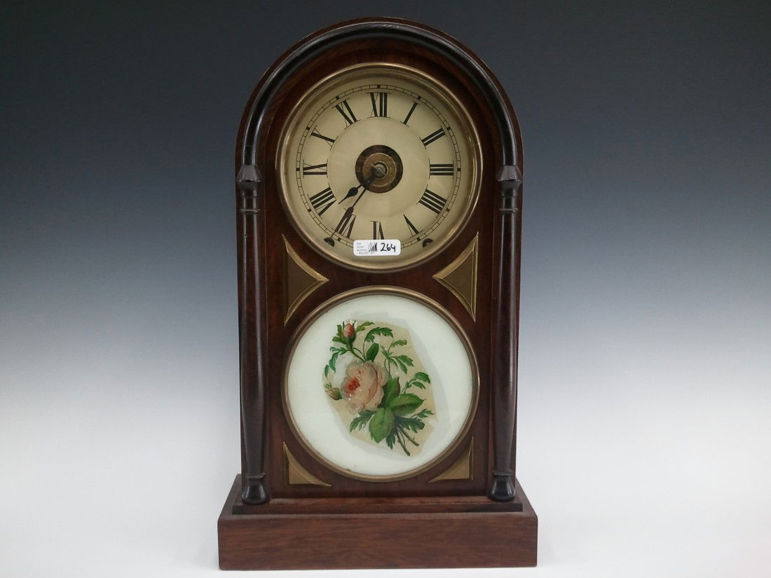 A SETH THOMAS ROUND TOP MANTEL CLOCK: 8 day, time, strike and alarm, nice original rosewood case, measures 17.5 x 10.25 x 4.25 inches. Replacement dial and touch up to door glass painting. Good running condition. Running condition is not