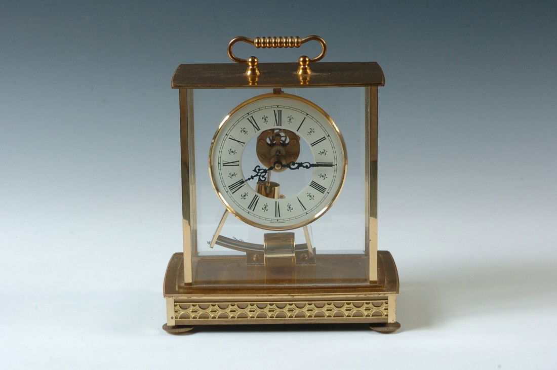 A SETH THOMAS BATTERY CLOCK: Back of clock reads 'Seth Thomas,' movement 'Kieninger & Obergfell, no jewels, unadjusted.' 9 x 7.75 x 5 inches overall.