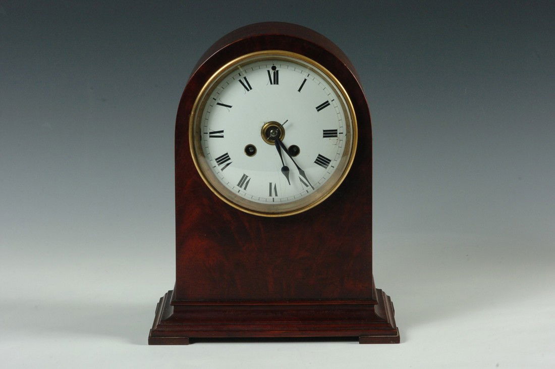 A SMALL FRENCH ANTIQUE MANTEL CLOCK: With enamel dial (chips and hairline) nice figured mahogany case, 10.5 x 8.5 x 5.25 inches overall. Good running condition. Running condition is not guaranteed once the clock is moved.