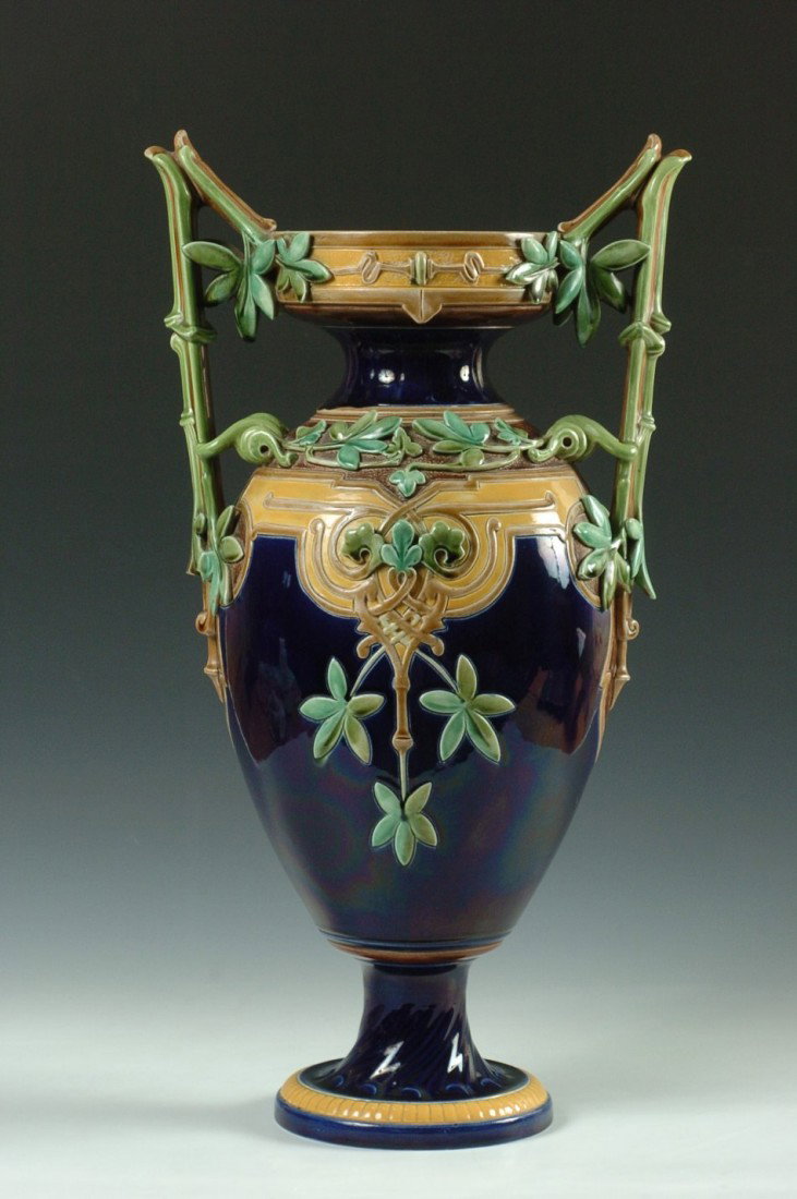 SARREGUEMINES FRENCH MAJOLICA FLOOR VASE, 24 INCHES: A beautiful floor vase with high handles in a bamboo motif, impressive amounts of applied three dimensional leaves and vinery, impressed markings of Sarreguemines and Majolica, numbered 505.