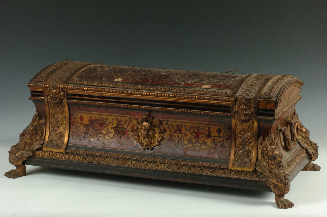 A LARGE BRONZE MOUNTED BOULLE CASKET AS FOUND: A French bronze mounted casket with heavy figural bronze corners terminating in hairy paw feet, acanthus trim, bronze masks front and back center, and at the top of each ormolu band, ornate bronze han
