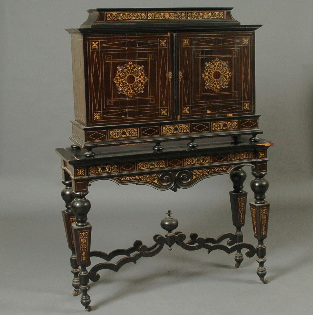 FLEMISH EBONIZED BAROQUE-REVIVAL COLLECTOR'S CABINET ON: In two parts: of architectural form surmounted by caddy cornice with finely inlaid tendrils and stones, rectangular projecting molded top over conforming case fitted with pair of doors each featuring 