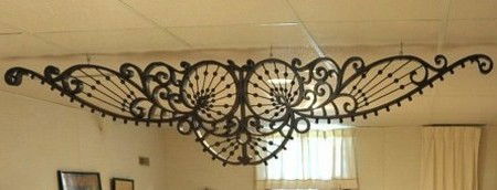 EXCEPTIONAL CURVILINEAR OAK FRETWORK STICK & BALL: An incredible piece of fretwork of scrolling and cylindrical designs cut from oak that measures two inches thick and with stick and ball design. Good dark older finish, measures 96.5 inches long and 2