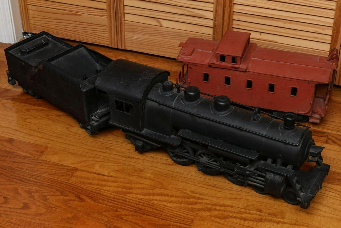A BUDDY L PRESSED STEEL LOCOMOTIVE, TENDER AND CABOOSE: The three pieces as shown include a locomotive, coal car and caboose. Enderman 9.5 x 25 x 6.75, middle car is 7.75 x 17.5 x 6.75, and caboose is 8.75 x 18.25 x 6.25 inches. We happily provide seamless