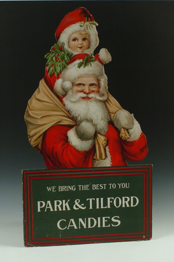 A RARE PARK & TILFORD CANDIES SANTA ADVERTISING DISPLAY: A circa 1900's die-cut chromolithographed easel-back advertising piece that measures 36 x 20 inches.