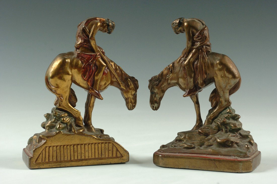 CIRCA 1930 AMERICAN INDIAN THEME BOOKENDS, BRONZE CLAD: A pair of bronze clad bookends attributed to the Pompeian Bronze Co. (unsigned), the figure composition is after the famous sculpture 'End of the Trail' by James Earl Frazier, designer of the Buffalo 