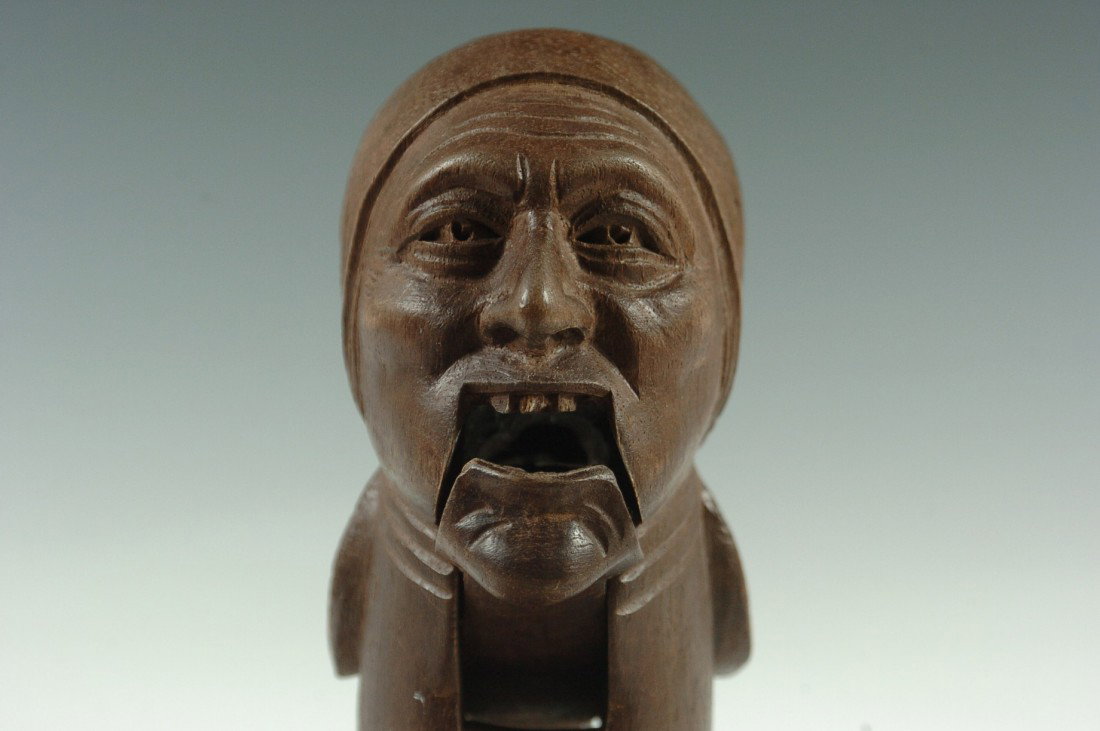 A BLACK FOREST CARVED WOOD ANTIQUE NUT CRACKER: The head of a peasant woman, measures 8 inches.