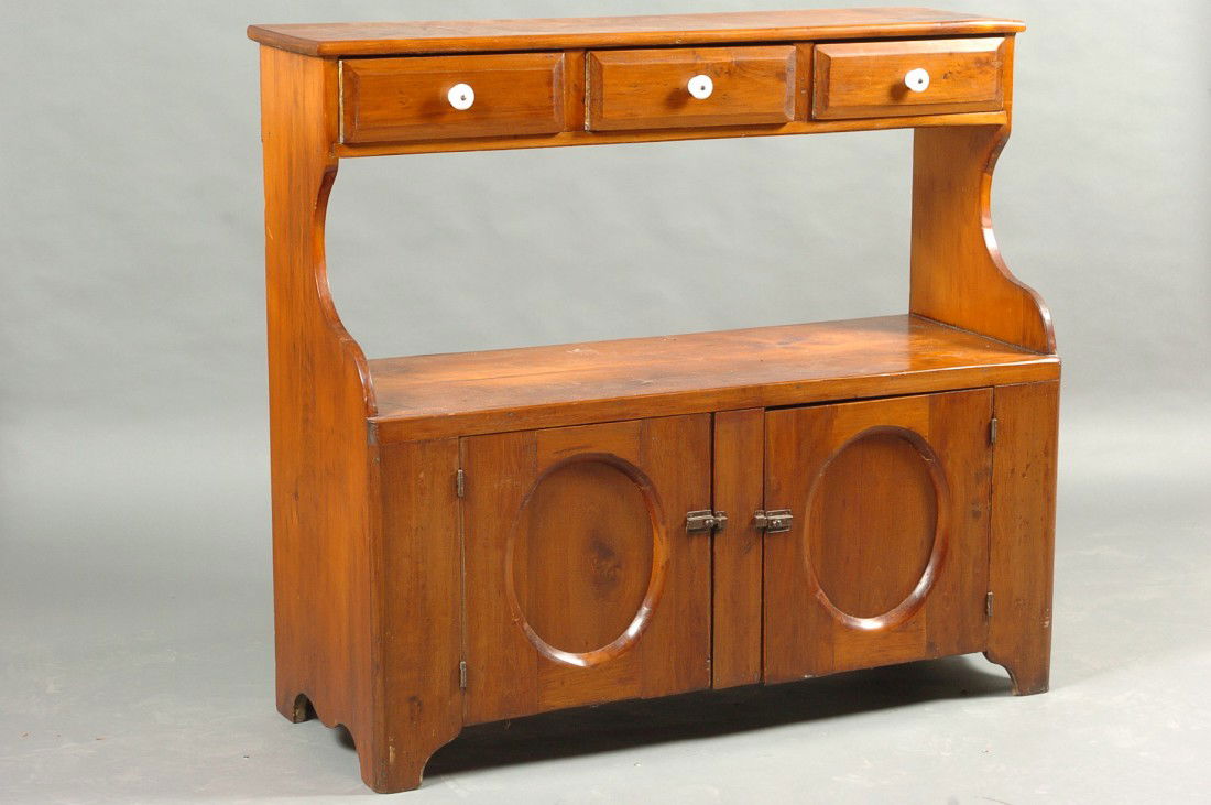 PRIMITIVE PINE BUCKET BENCH: Three hand chamfered and dovetailed drawers over work / bucket area and oval drop panel doors, measures 43 x 48 x 17, nice mellow old color.