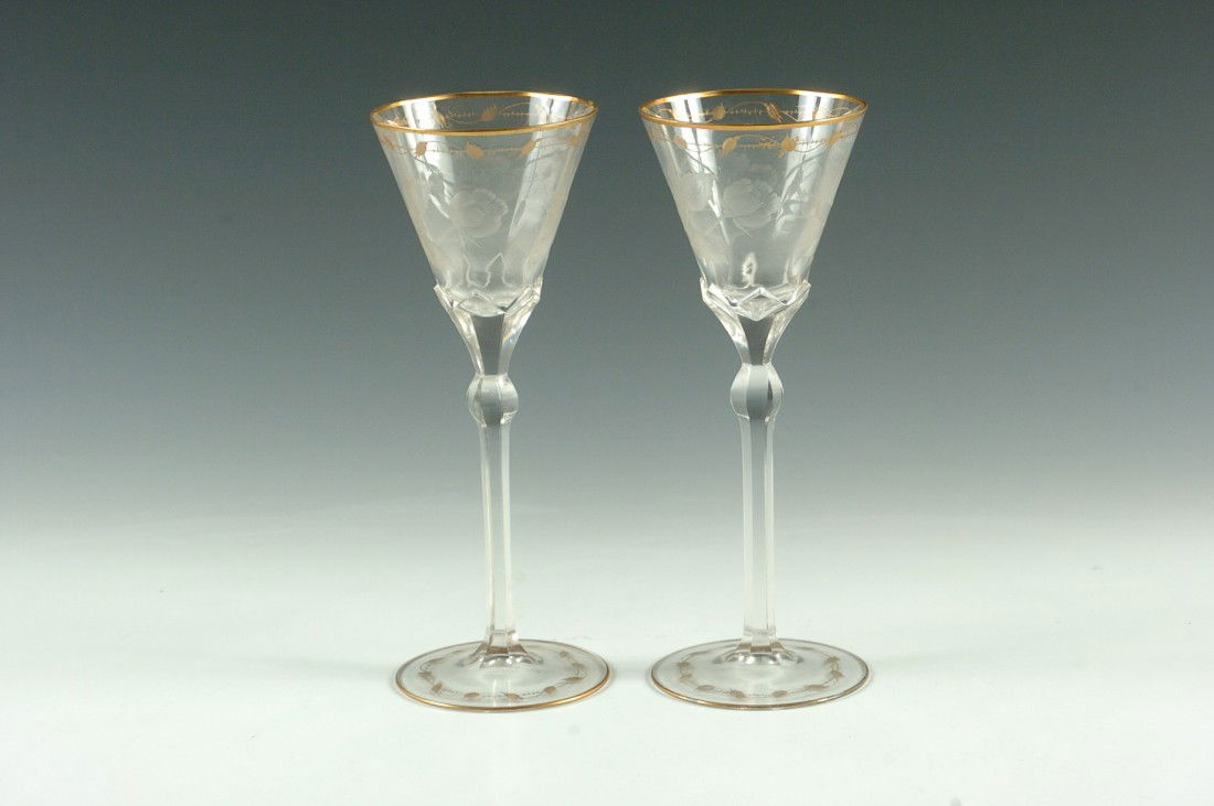 A FINE PAIR OF MOSER QUALITY INTAGLIO CUT STEMS: With gilded etched designs, intaglio cut florals and polished stem and foot with additional etching and gold. Measure 9.25 h x 3.5 inches, each.