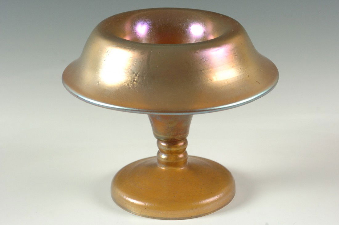 A GOLD LOETZ VASE WITH FOLDED RIM: A footed vase that measures 5 h x 5.5 w inches, acid stamp of 'Czecho-slovakia' in oval that is generally known to be a mark associated with the Loetz factory.