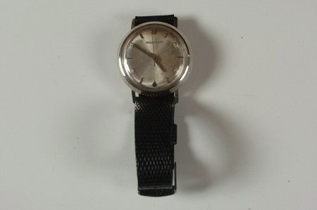 A BULOVA ACCUTRON MEN'S WRISTWATCH WITH DIAMONDS: A Bulova 10K gold-filled watch with diamonds at 2, 4, 8 and 10. #C94695.