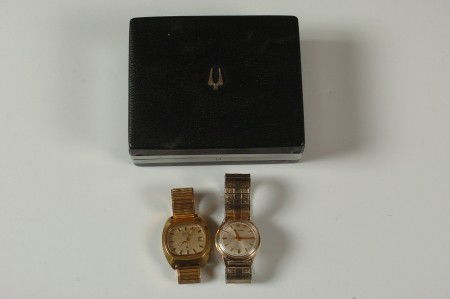 TWO BULOVA ACCUTRON WATCHES AND ACCUTRON BOX: Rectangular watch #842122 and round, #89927.