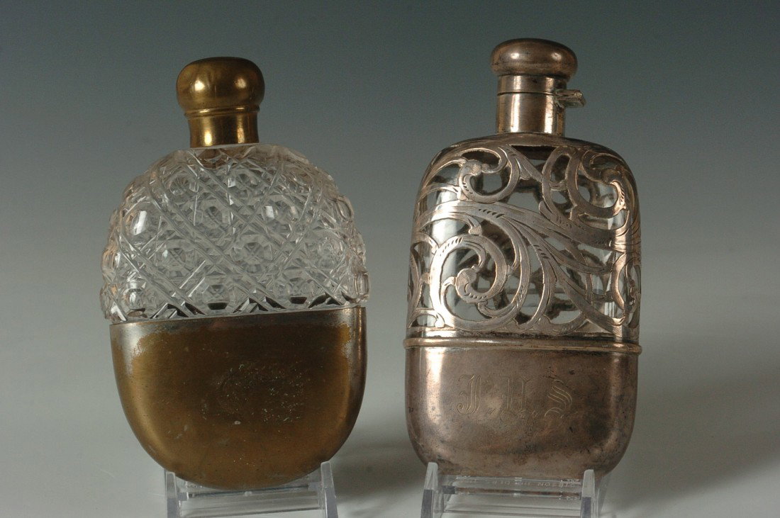 VICTORIAN STERLING SILVER OVERLAY FLASK, PLUS ANOTHER: A nice heavy overlay of hand engraved sterling silver over glass, measures 6 x 3 inches, marked sterling. Plus a 5 x 3 inch pressed bottle with worn brass.
