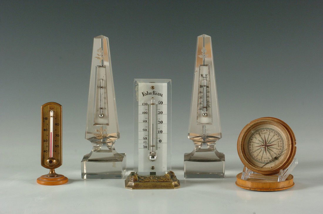 FIVE ANTIQUE THERMOMETERS AND COMPASS: Two crystal obelisks with engraved flourish and set with a mercury thermometer on milk glass 7.75 inches, plus a brass base thermometer with painted glass 5.5 inches and a catlin based thermometer 4 i