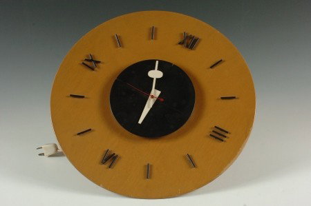 GEORGE NELSON ELECTRIC WALL CLOCK BY HOWARD MILLER: Wood base with applied metal Roman numerals, sweep second hand. Functional. Partial Howard Miller decal to reverse, white cord and plug. Measures 14 inches in diameter.