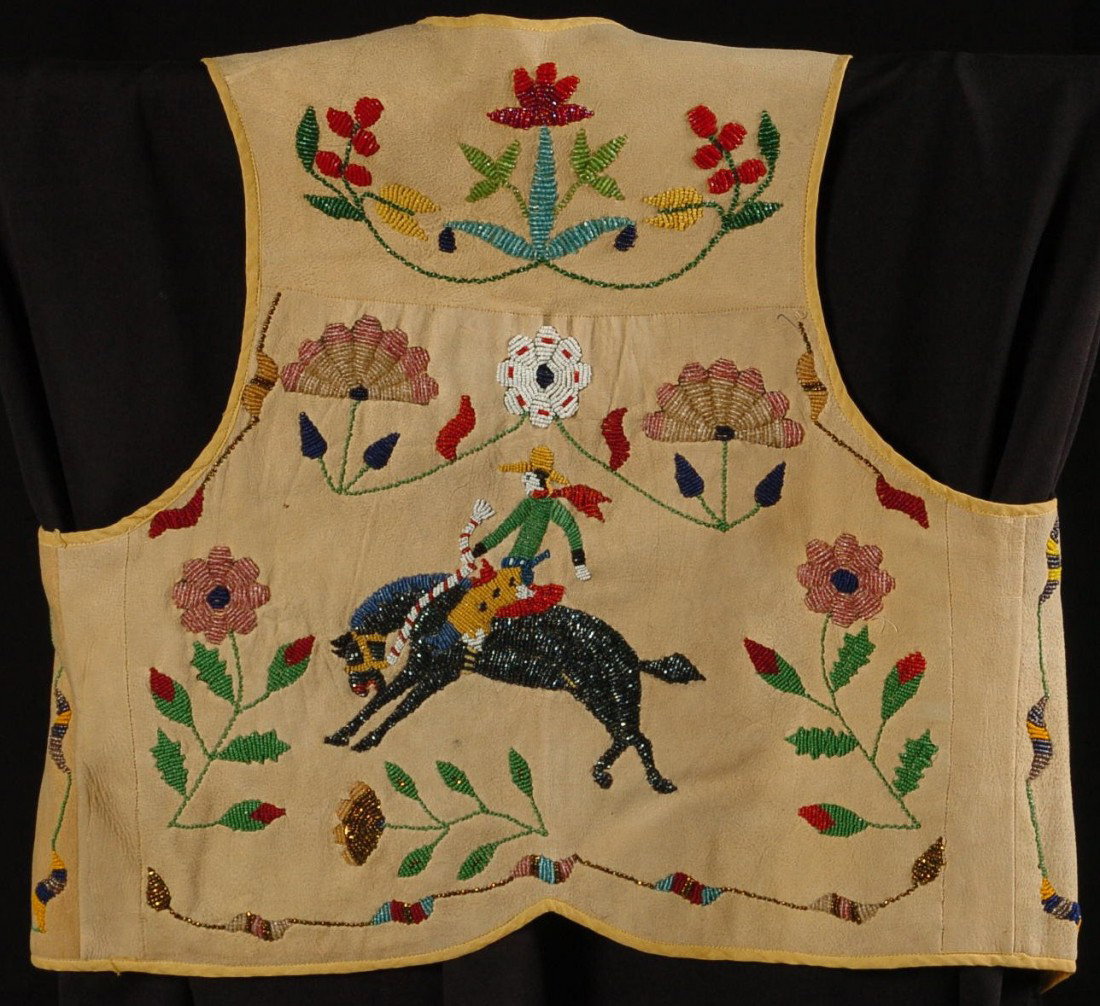 CIRCA 1920 SANTEE SIOUX BEADED CHILD'S VEST WITH COWBOY: Santee Sioux, partially beaded figural vest, beaded buckskin with cloth stripe lining, yellow cotton machine sewn ribbon edging, nineteen different bead colors and bead types depicting floral designs 