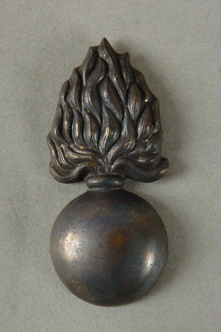 CIVIL WAR ERA ORDNANCE KEPI BADGE: Stamped brass hollowback, double prongs. Measures 2.25 inches long.