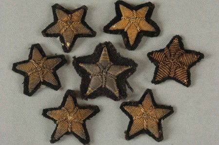 SEVEN BULLION LINE STARS: Seven USN style gold bullion on black line stars.