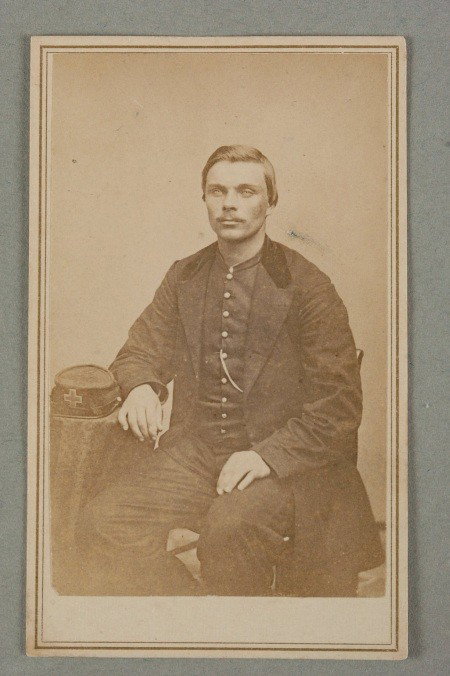 CDV OF UNION ARMY 6TH CORPS SOLDIER: Image on cardstock, shows seated man next to his kepi with a 6th Corps badge. 4 x 2.5 inches.