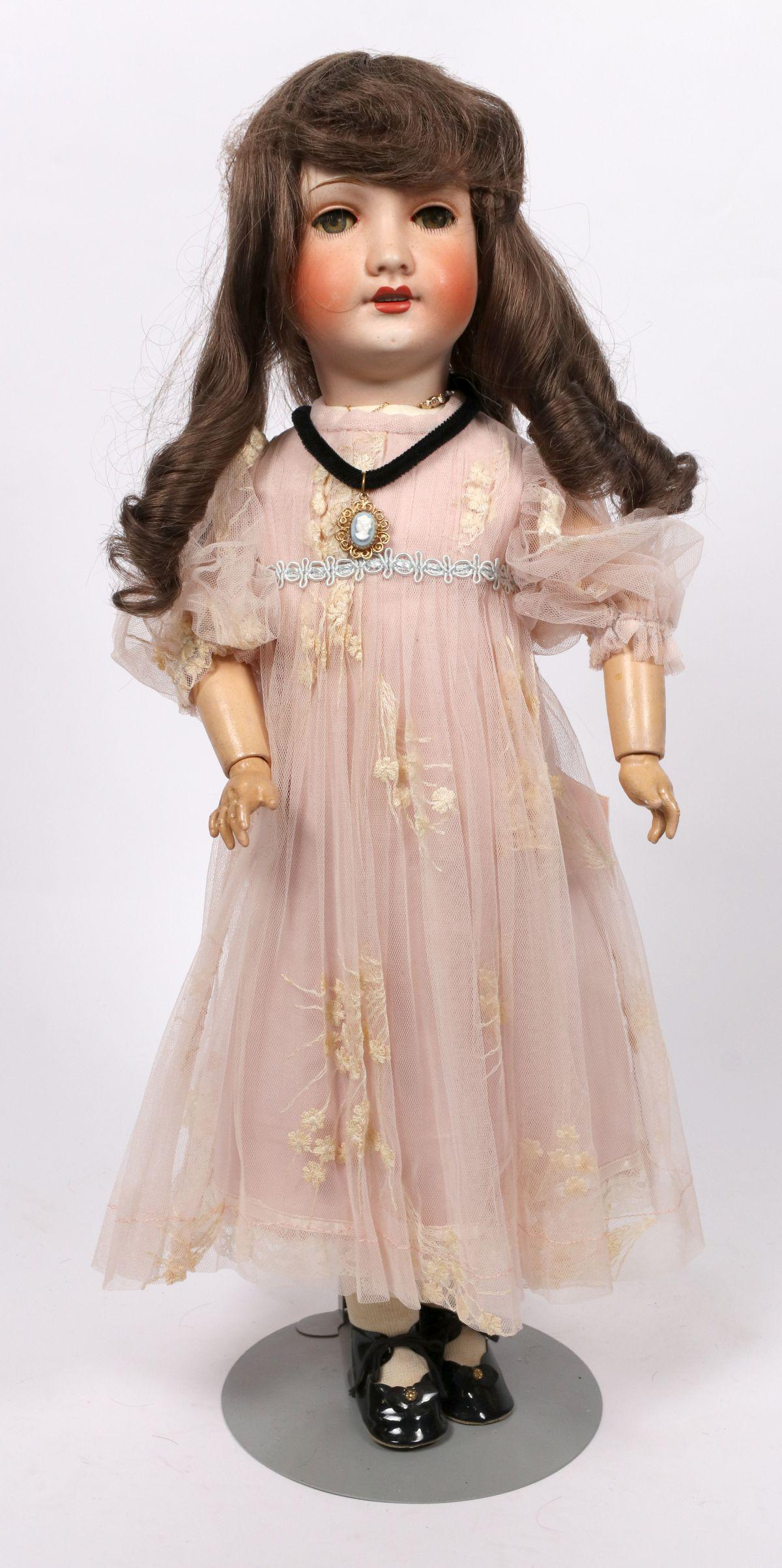 A UNIS FRANCE BISQUE HEAD DOLL: The ball jointed body in original condition is set with a bisque socket head having painted details, flirty sleep eyes, open mouth with teeth and impressed markings of 71 UNIS 149 FRANCE 301. Measures