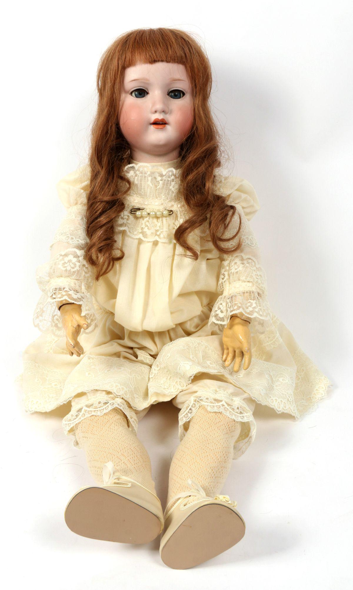 A 30-INCH ARMAND MARSEILLES BISQUE HEAD DOLL 246/1: The ball jointed body is set with a socket bisque head having hand painted features, sleep eyes, open mouth with teeth and impressed marks of DRGM 246/1 A 13 M . Measures 30.5 inches. Without proof of