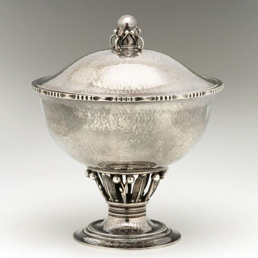 A GEORG JENSEN PRE-1932 LOUVRE BOWL #180 WITH COVER: The iconic early design by Georg Jensen is found here with an unusual lid, cover, with decorative orb and ball-capped tendrils. What follows is an excerpt from Janet Drucker's book, George Jensen A Tr