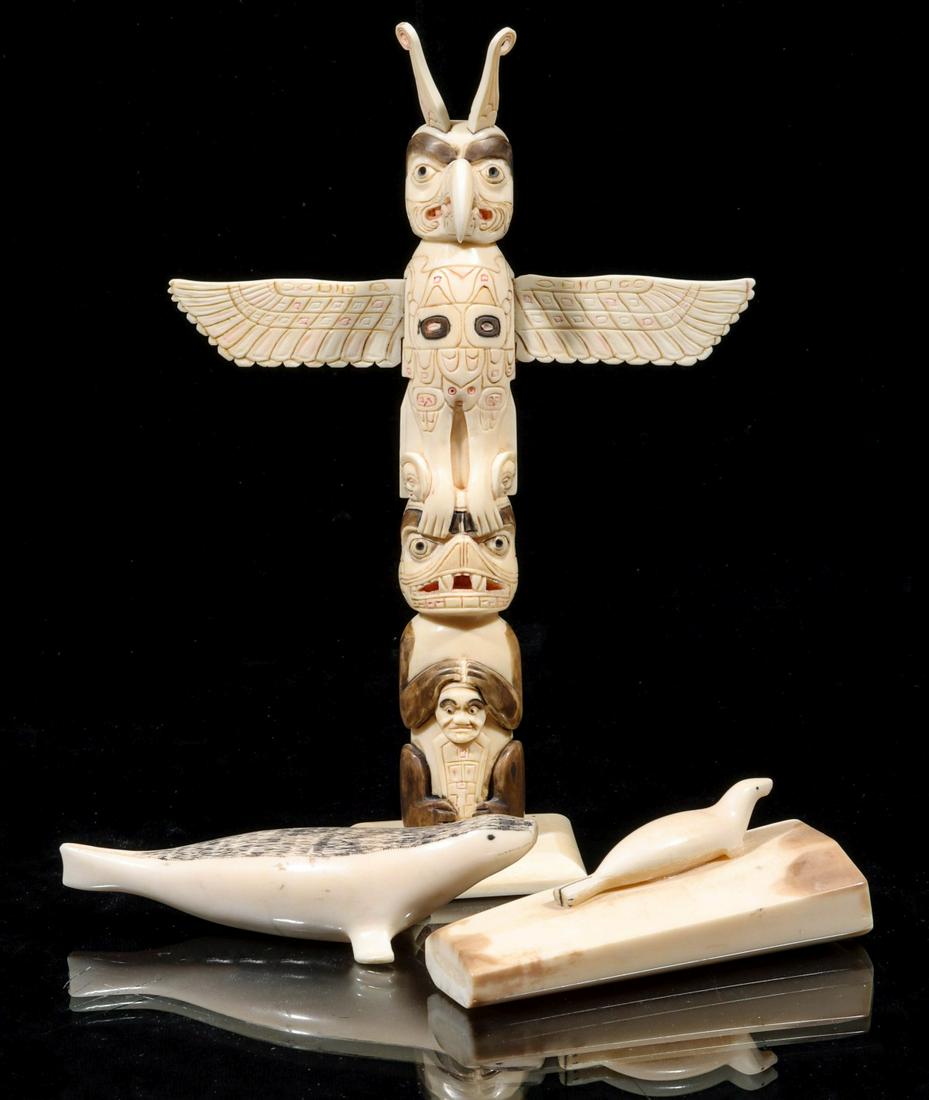 THREE NATIVE INUIT CARVINGS INCLUDING A TOTEM POLE: The three carvings from walrus tusk are offered as shown. Sizes range from 1 x 4.25 x 1.5 to 7.25 x 5 x 1.5 inches. Provenance: The collection of Josephine Bird Hall (1888 - 1948) by descent to her so
