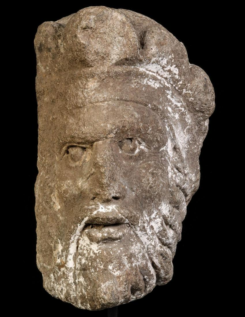 A LARGE CARVED OR CAST STONE HEAD FRAGMENT (1 of 8)