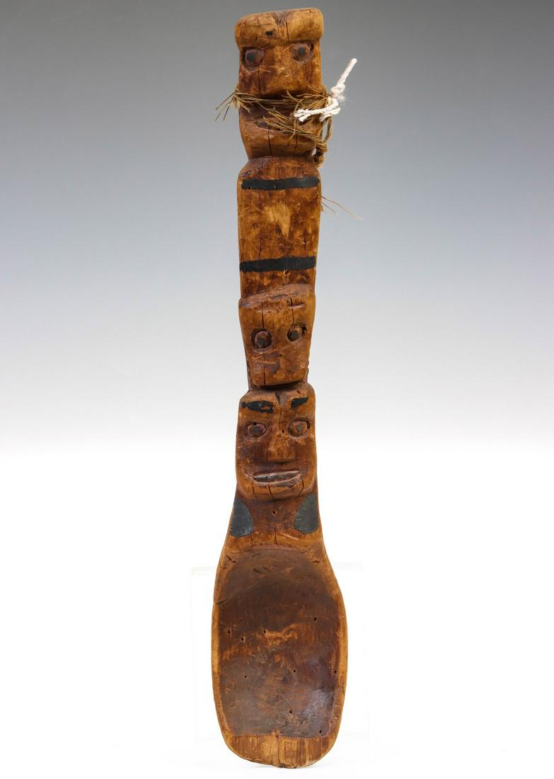 A CARVED SPOON OF UNKNOWN ORIGIN WITH TOTEMIC FIGURES: The large spoon is carved from a single piece of wood. Measures 16.75 x 3 x 3 inches. Provenance: The Susan Koehn Estate Trust Newton, Kansas Without proof of exemption, be aware that internet sales t