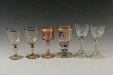 LOT OF BOHEMIAN, STEUBEN AND OTHER WINE GOBLETS: Including Moser style goblets one with heavy gold and cranberry cased panels the other with heavy gold and ruby flash highlights. Plus a pair of goblets with engraved bowls and swirled green glass ste