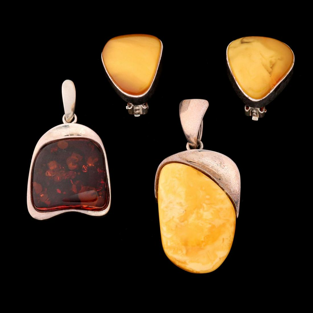 AMBER AND STERLING SILVER EARRINGS AND PENDANTS: The lot of jewelry marked 925 is offered as shown. Earrings measures 1 x 0.75, pendants are 2 and 2.25 inches. Total weight of 1.2 ozt. Provenance: The Susan Koehn Estate Trust - Newton, Kansas Withou