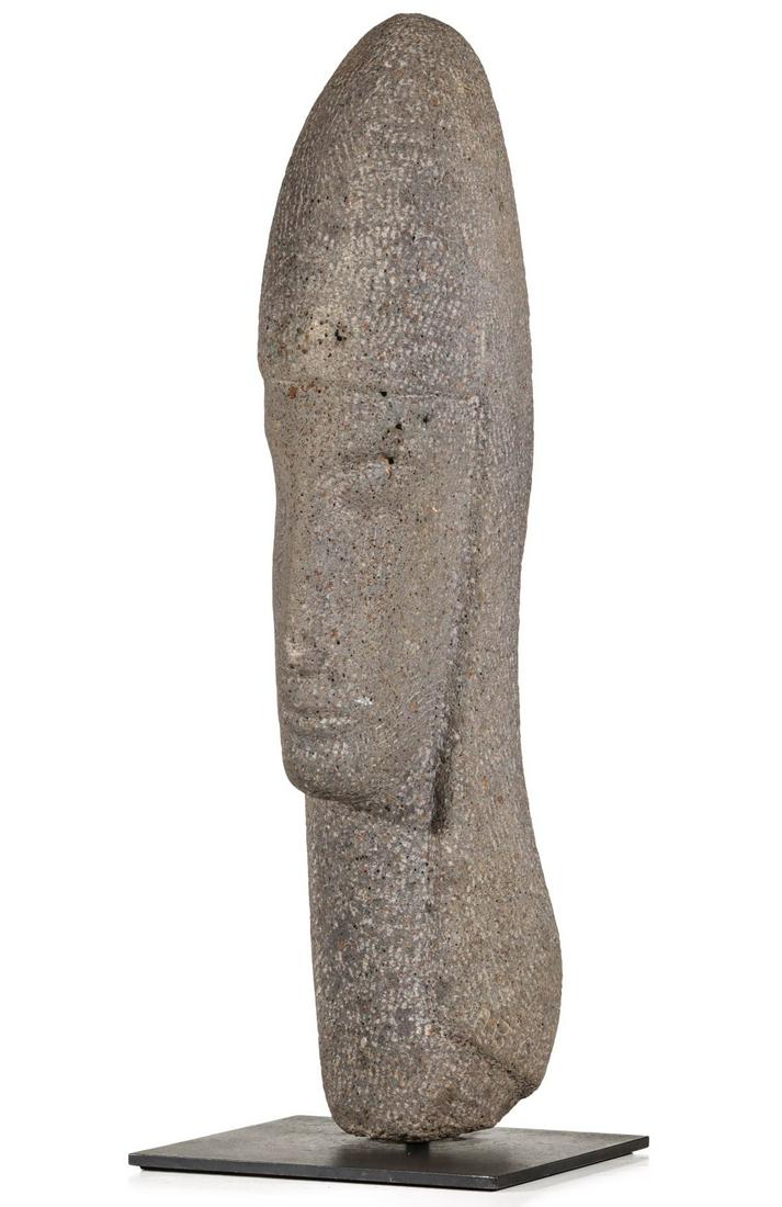 A MODERNIST CARVED GRANITE HEAD OF ROMAN SOLDIER: The grey granite carving of soldier in a conical helmet is signed AB and dated 64. Measures 23.25 x 4.5 x 7 inches and weighs 40 pounds. AN ABSENTEE BID PLACED IN ADVANCE COULD LOSE TO A LIVE BID OF E