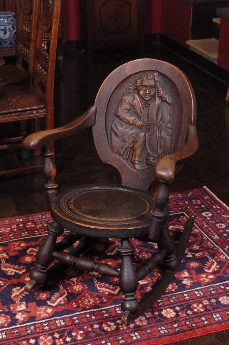 OAK ROCKING TAVERN CHAIR WITH DEEP BACK: Original dark finish, measures 32 x 33 x 34 inches.