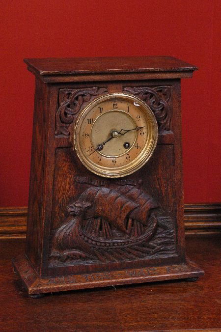 GERMAN ARTS & CRAFTS CARVED OAK CLOCK "TIME AND TIDE WA: Circa 1900, great original finish and resulting warm dark oak patina, bas relief carving of a ship and scroll ornaments in each corner - the well-known phrase carved around the base, measures 13 x 10.
