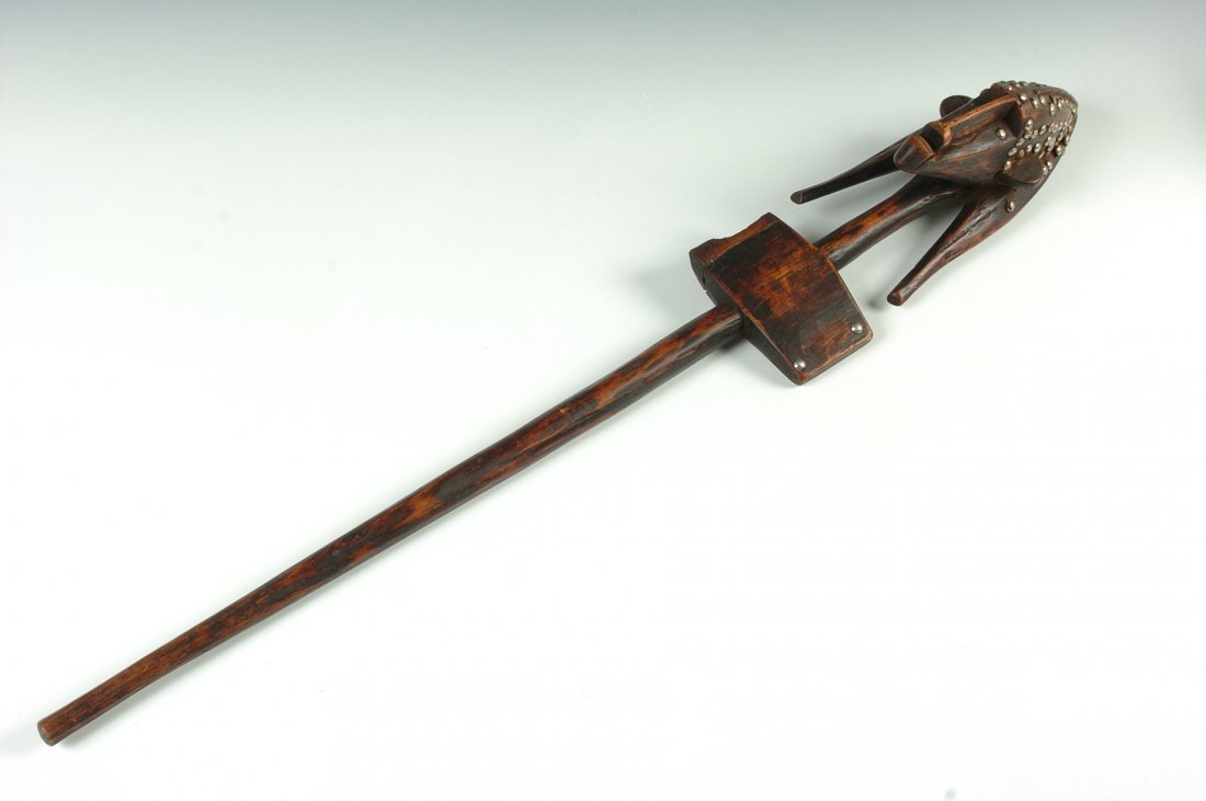 BAMBARA JUDICIAL WAND, MALI: Wand in the form of a stylized male head with silver colored tacks in the head and for eyes. 36 x 5 inches.