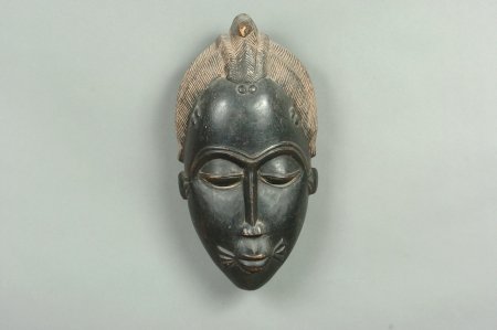 BAULE MASK OF A WOMAN, IVORY COAST: Agricultural festivities mask of a woman's face with sear marks. 15.5 x 9 inches.