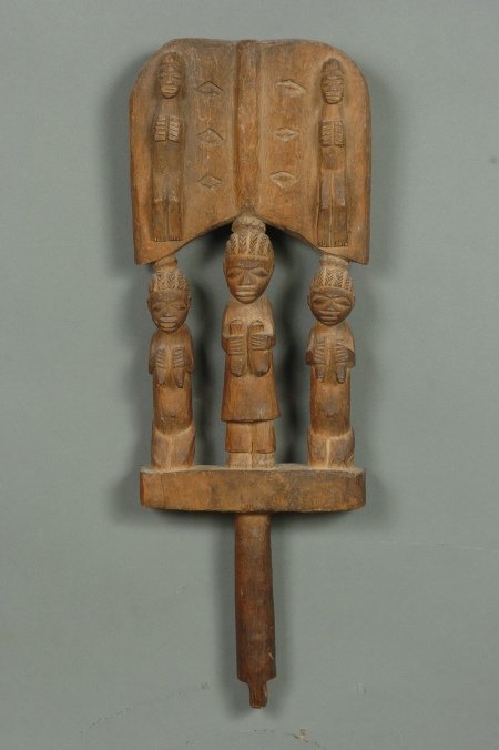 YORUBA SHANGO DANCE WAND, NIGERIA: Circa 1940, dance wand depicting two kneeling women flanking a standing man. Used in festivals worshiping Yoruba, the thundergod. 17 x 6 inches.