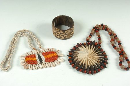 NEW GUINEA BRACELET & NECKLACE, PLUS A SHELL NECKLACE: Necklace made of seeds and beads, 26 inches with 5 inch pendant and a 3 inch diameter woven bracelet, both from New Guinea. Plus, a cowry shell and bead necklace, 24 inches with a 3 x 5.5 inch pendant