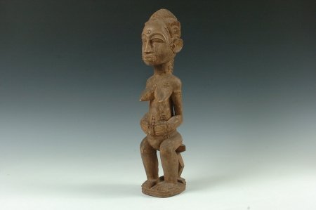 BAULE FEMALE FIGURE, IVORY COAST: Pregnant Woman Society female figure seated on a two legged stool, meant to be visited once a month and anointed with palm and cola nut oil. 18 x 4 inches.