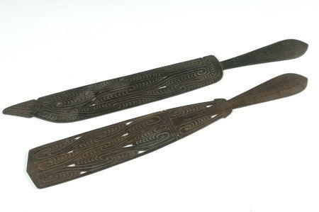 PAPUA NEW GUINEA EBONY SPATULAS AND FIGURE: Pair of decorative lime spatulas, incised and pierced, 21 and 18.5 inches. Plus a 22 inch carved wood figure.